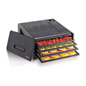 Excalibur 4400 4 tray compact dehydrator with door propped to the side and food on the trays.