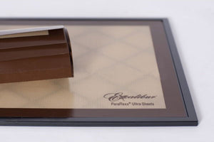 Excalibur Paraflexx Ultra silicone dehydrator drying sheet on a tray with a roll of sheets placed on top.