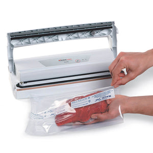 Magic Vac Alice vacuum packing system with lid open and food being placed into a vacuum packing bag.