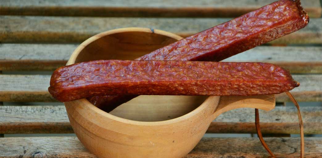 'Malinkies' - A quick 'cheat' Jerky recipe - Dehydrated Sausage or Dehydrated Twiggy Snack Sticks on wooden bowl.