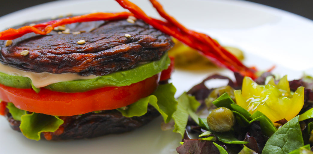 Raw Dehydrated Portobello Mushroom Vegetarian Burgers with Avocado, Tomato, Salad and Red Capsicum