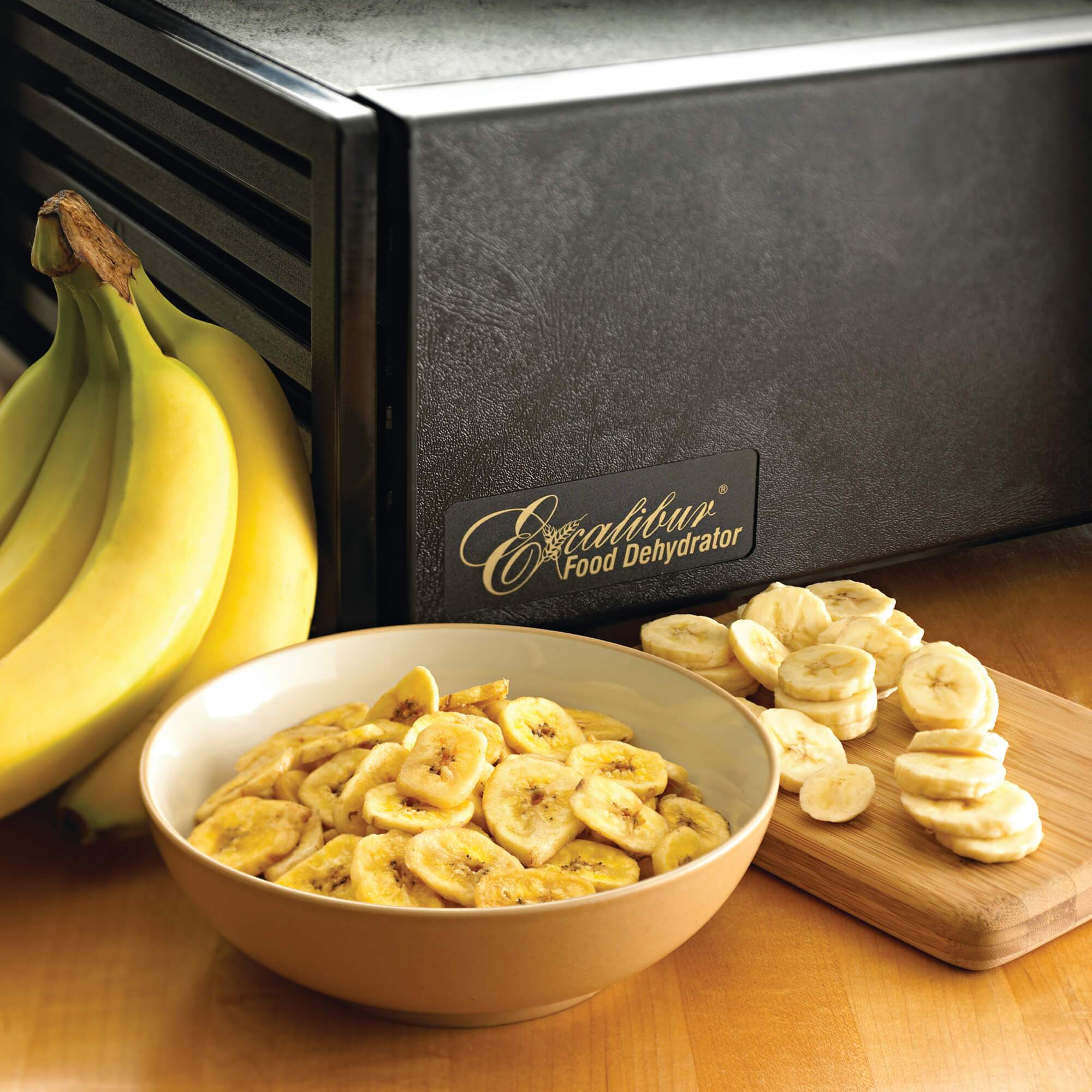 Excalibur 4500B 5 tray dehydrator with banana chips in a bowl.
