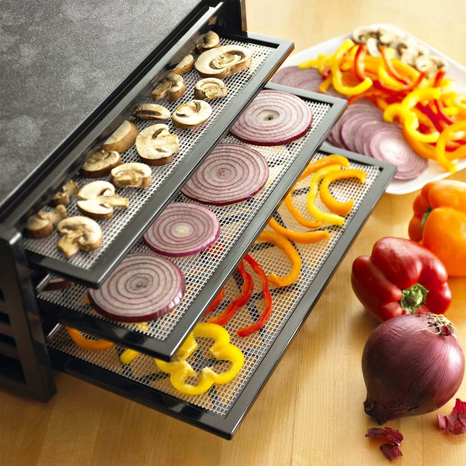 Excalibur 4400 4 tray dehydrator with an assortment of vegetables placed on the trays.