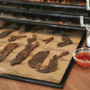 Excalibur ParaFlexx Premium teflon dehydrator drying sheet on a tray with jerky placed on the sheet.