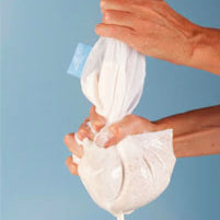 Living Synergy nut milk bag being squeezed out.